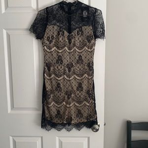 Black lace dress with nude slip underneath. Size M